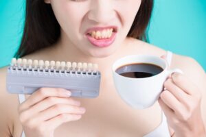 woman take tooth color palette and coffee with whiten concept